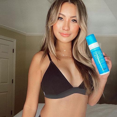tanned woman in Coconut Water Self Tan Foam